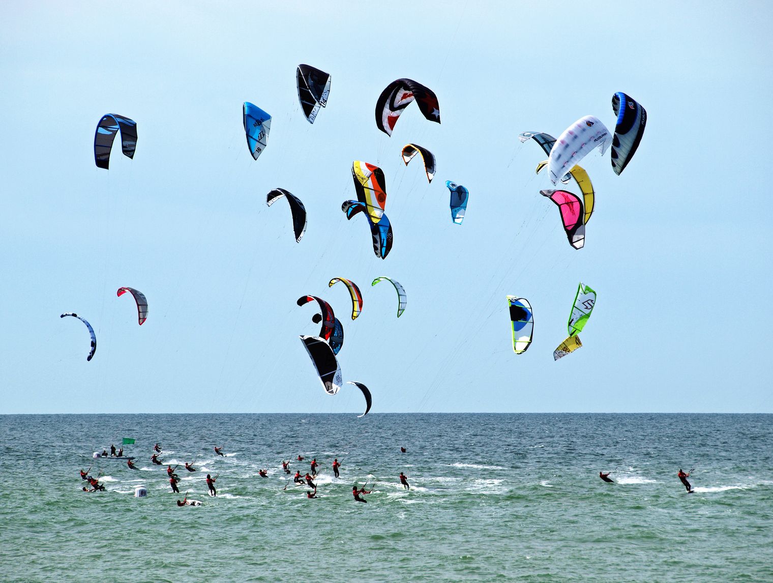 Viele Kitesurfer mit bunten Schirmen beim Rennen auf der Nordsee