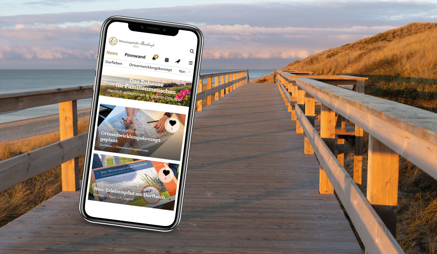 Wenningstedt App auf dem Handy vor einem Strandhintergrund