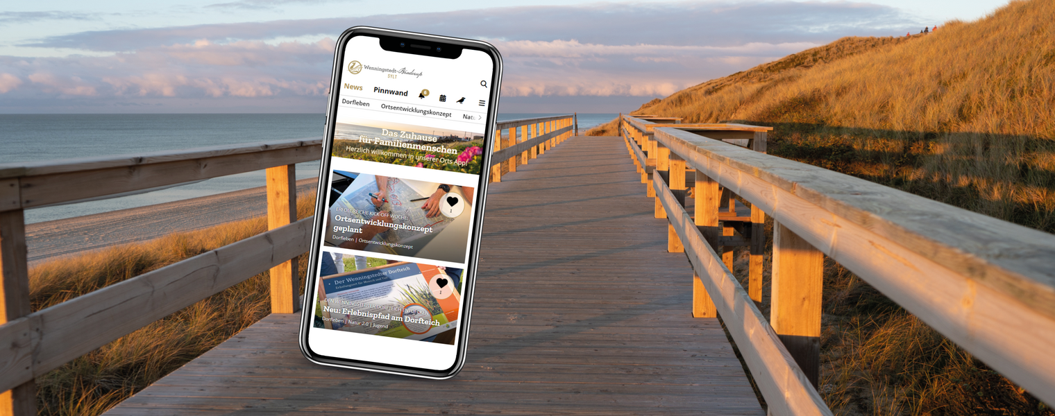 Wenningstedt App auf dem Handy vor einem Strandhintergrund