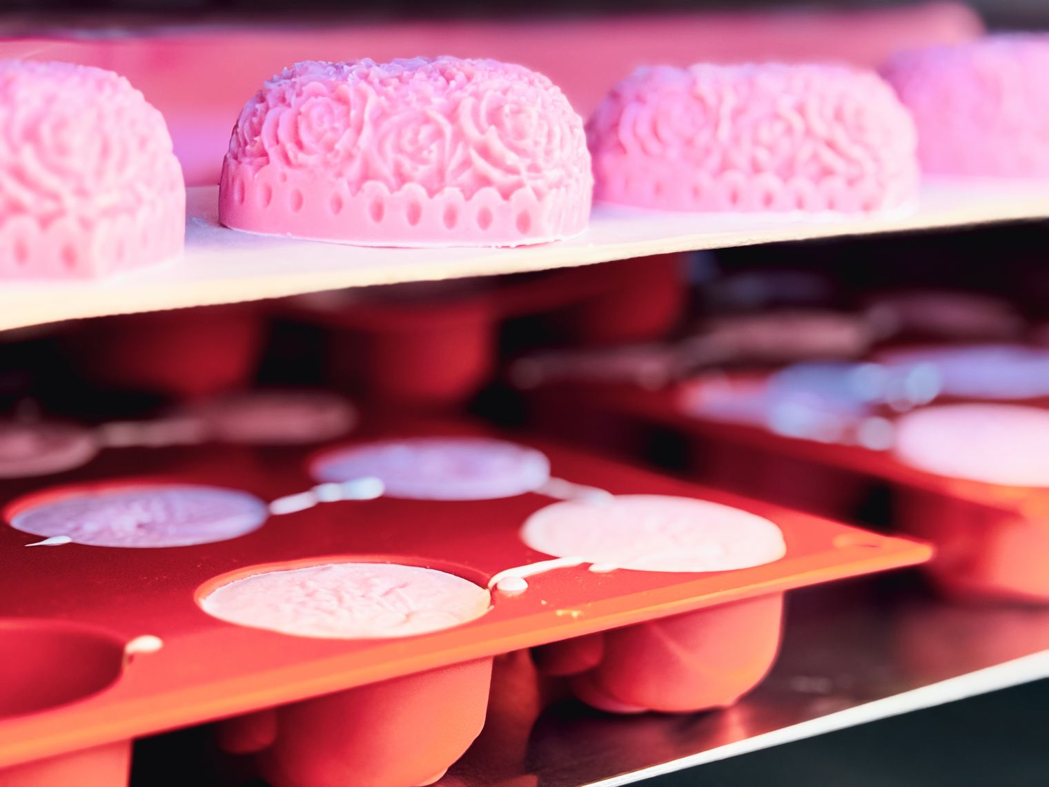 Rosafarbene Seifen auf mehreren Regalböden