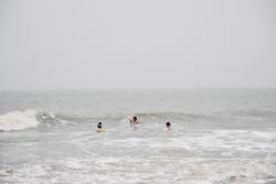 Drei Männer baden im Winter in der Nordsee vor Westerland auf Sylt.