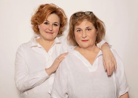 Zwei Frauen mit rötlichem Haar umarmen sich.